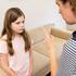 Mother scolding her daughter in living room